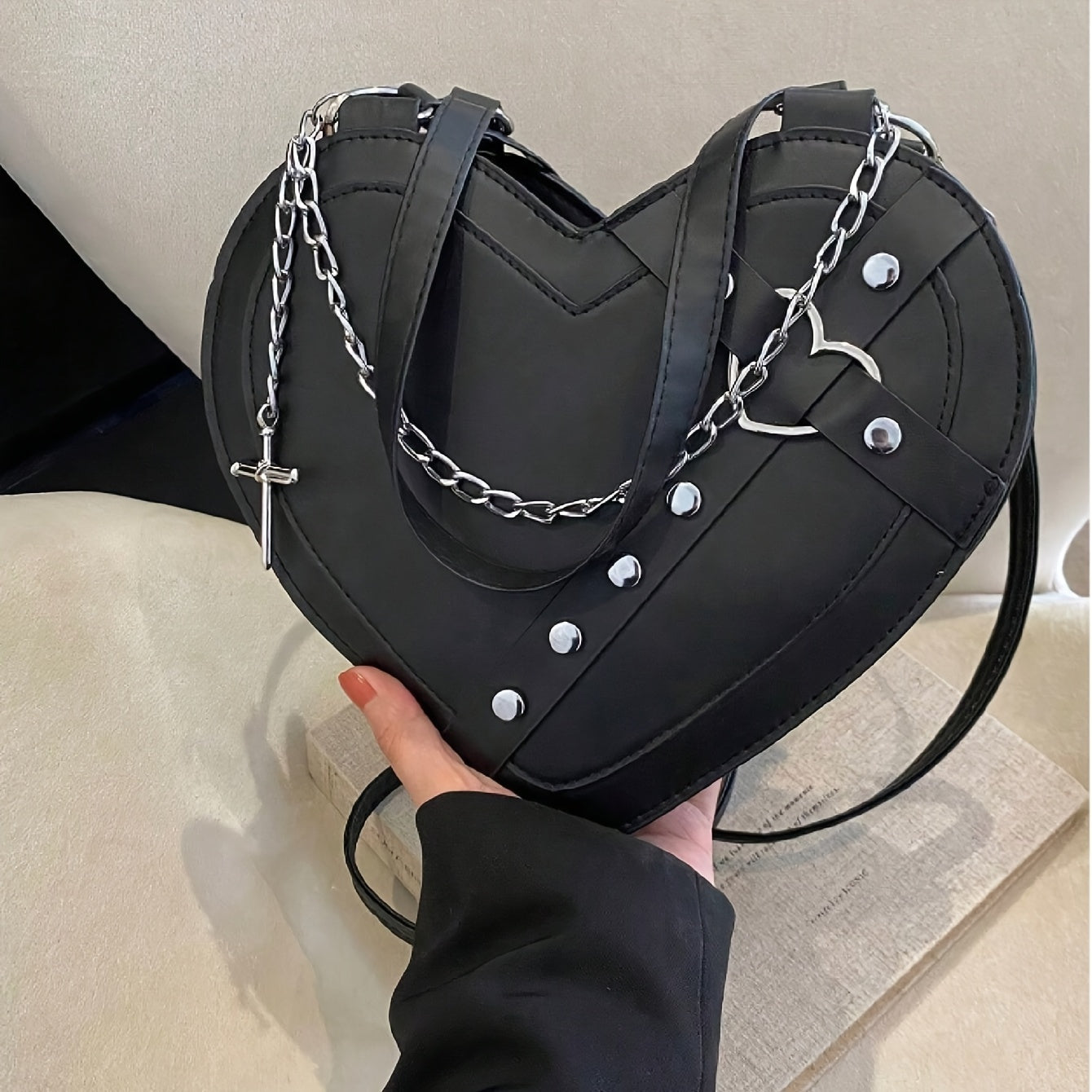 Front detail of gothic heart bag showing chain strap, rivet edging and heart hardware from Alternative Darkwear
