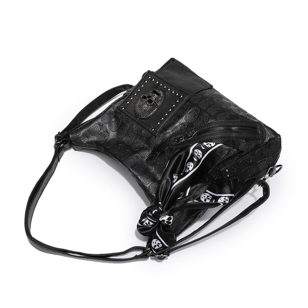 Gothic skull embossed hobo shoulder bag in matte black PU leather with tassel hardware and multi-strap options from Alternative Darkwear