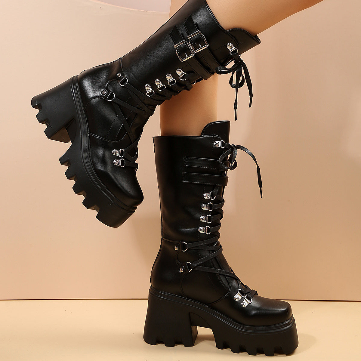 Matte black alternative darkwave lace up knee high boots women bat buckle detail close up shaft view