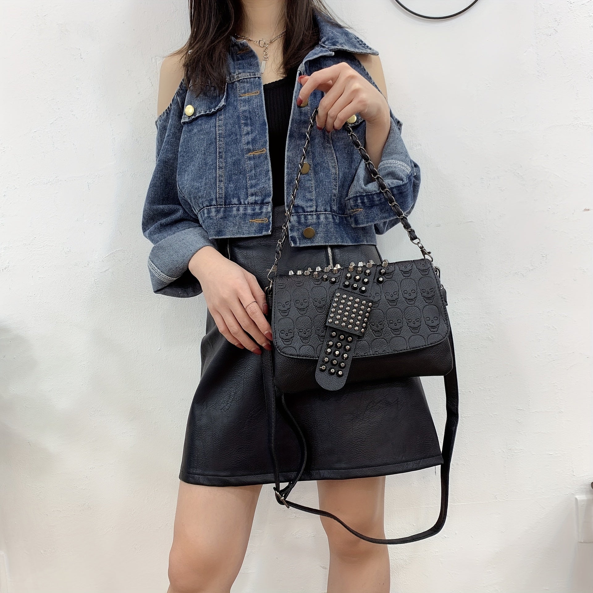 Studded skull rivet crossbody bag showing adjustable strap and structured silhouette from Alternative Darkwear